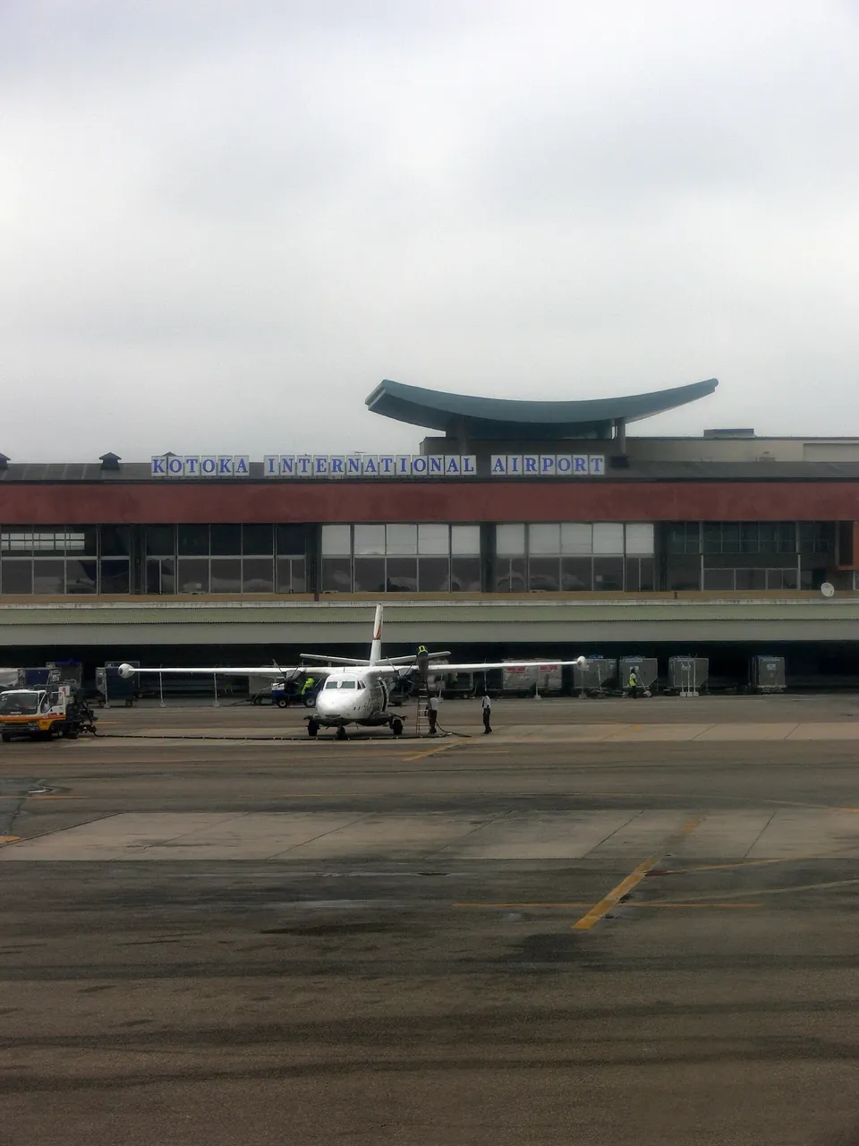 The older terminal building at Accra’s airport with its Kotoka International Airport sign, photographed from the apron before the 2026 renaming
