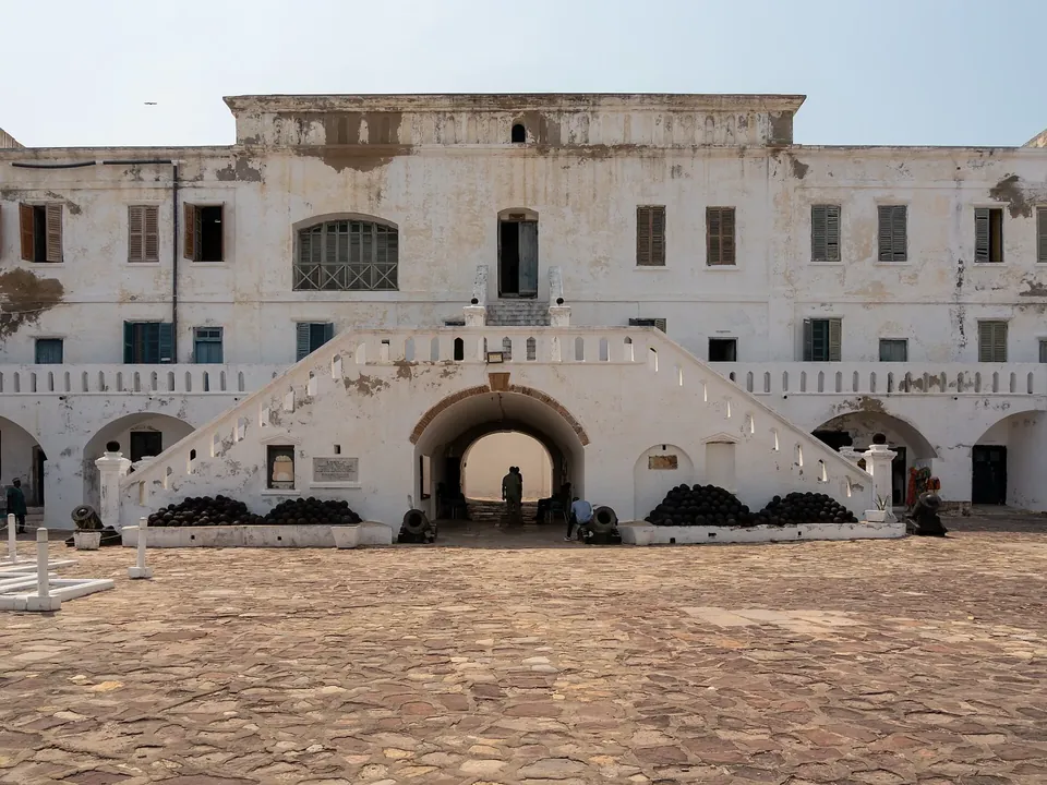 The whitewashed walls and cannons of Cape Coast Castle above the Atlantic