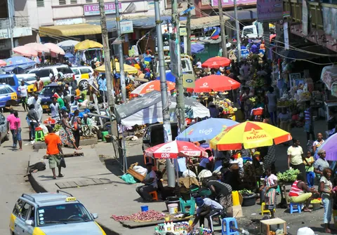 Busy streets, market stalls and taxis at Market Circle in Takoradi, seen from above
