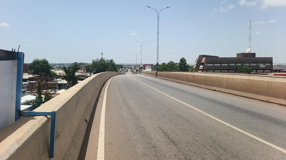 A wide, empty two-lane flyover in Tamale with street lights, linking the Tamale–Kumasi road to the Tamale–Bolgatanga road