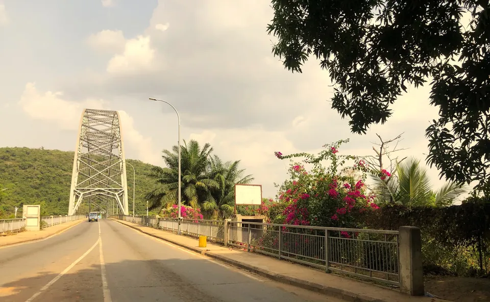The steel arch of the Adomi Bridge over the Volta River at Atimpoku, seen from the road