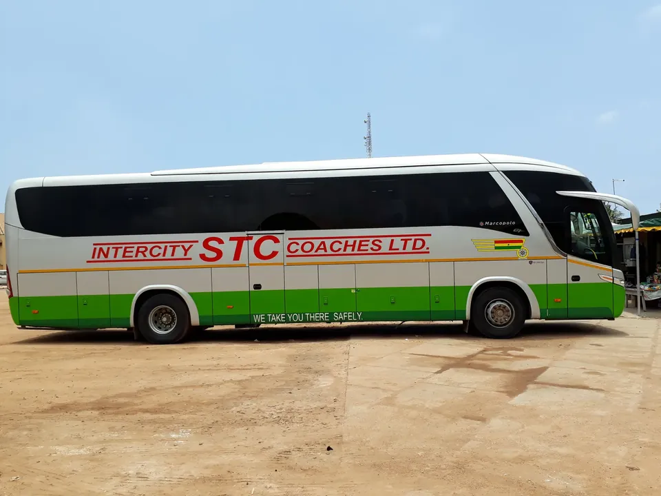 A white and green air-conditioned Intercity STC coach parked at the STC yard near Kwame Nkrumah Circle in Accra, Ghana