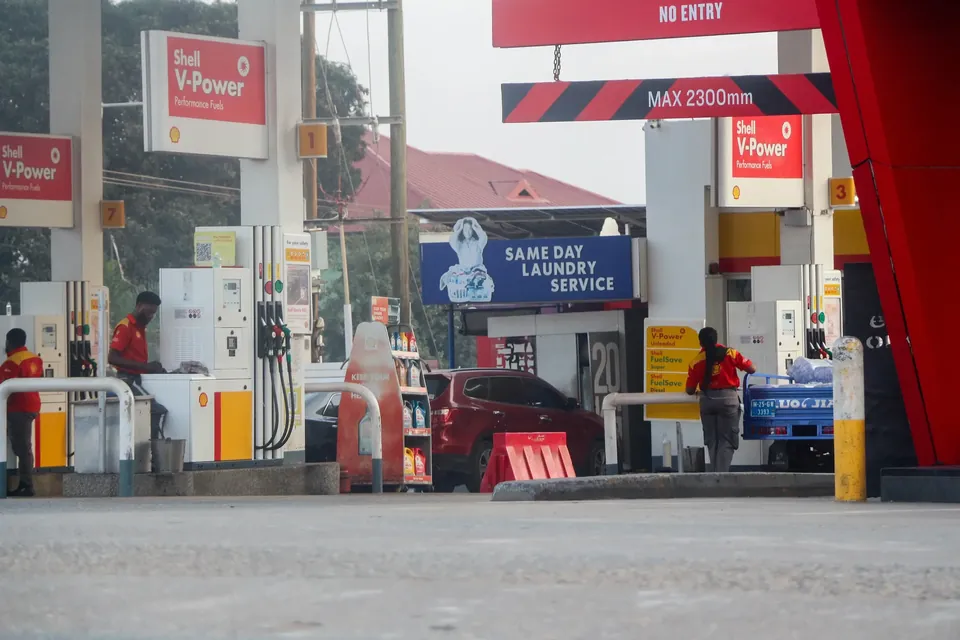Fuel pumps and attendants at a filling station in Accra, Ghana