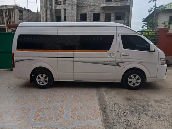 Joemay - white Foton minibus, side view